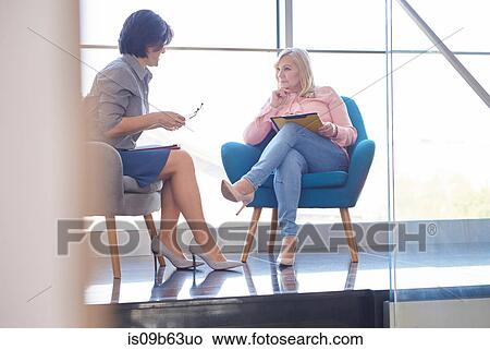 Business women having discussion in meeting View Large Photo Image Picture - Business women having discussion in meeting. Fotosearch