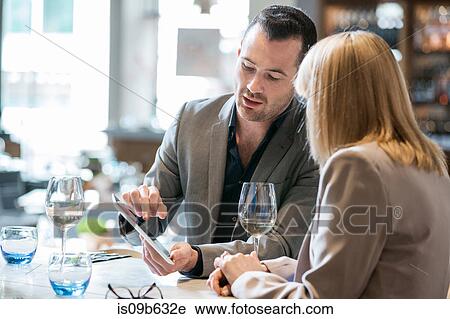 Businessman and businesswoman at lunch in restaurant View Large Photo Image Stock Image - Businessman and businesswoman at lunch in restaurant. Fotosearch