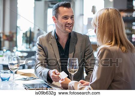 Businessman and businesswoman making introductions at lunch in restaurant View Large Photo Image Stock Image - Businessman and businesswoman making introductions at lunch in restaurant. Fotosearch
