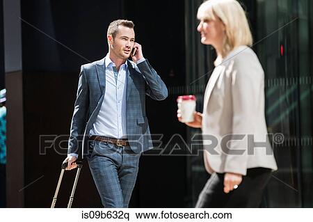 Stock Photography - Businessman and businesswoman on street. Fotosearch