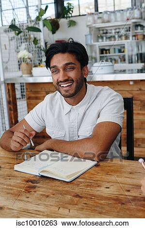 Stock Image - Businessman at office meeting. Fotosearch