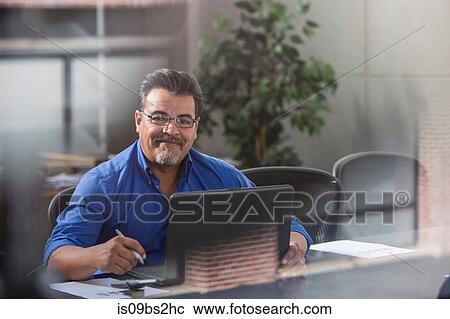 Businessman using laptop in office View Large Photo Image Stock Image - Businessman using laptop in office. Fotosearch