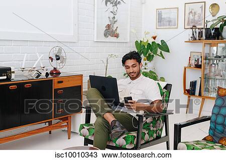 Businessman using laptop in office View Large Photo Image Stock Image - Businessman using laptop in office. Fotosearch