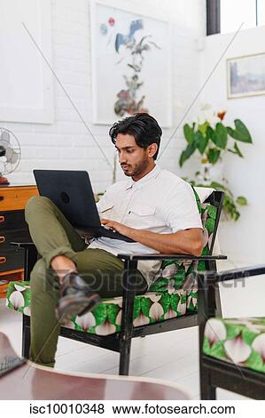 Businessman using laptop in office View Large Photo Image Stock Photo - Businessman using laptop in office. Fotosearch