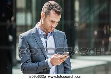 Stock Photography - Businessman using mobile phone. Fotosearch