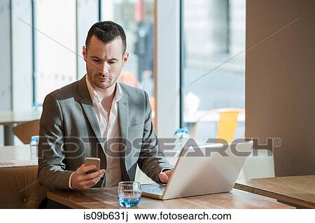 Businessman working in cafe View Large Photo Image Stock Image - Businessman working in cafe. Fotosearch