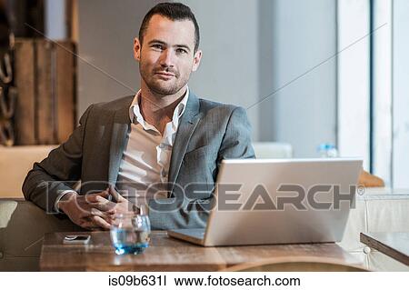 Stock Image - Businessman working in cafe. Fotosearch