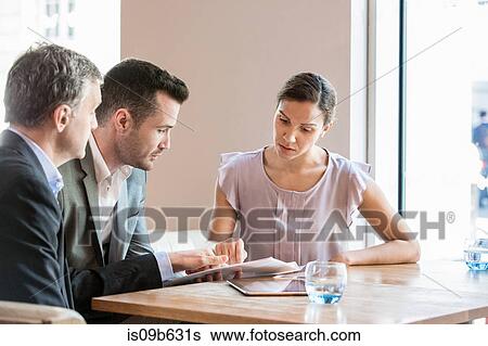 Stock Photograph - Businessmen and businesswoman working. Fotosearch