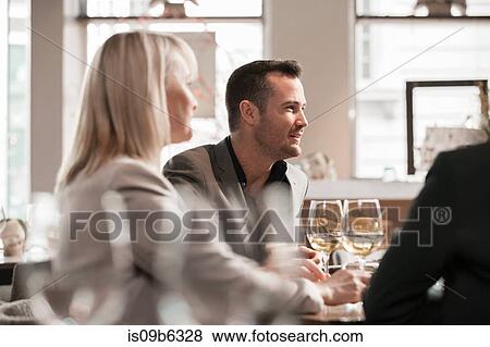 Businessmen and businesswomen at lunch in restaurant View Large Photo Image Stock Photo - Businessmen and businesswomen at lunch in restaurant. Fotosearch