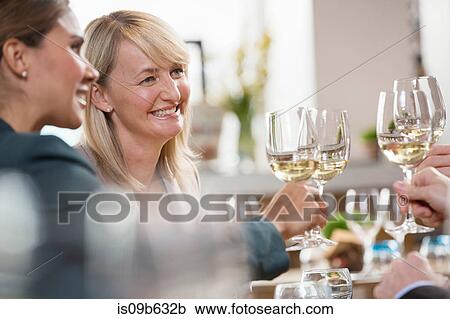 Stock Image - Businessmen and businesswomen toasting. Fotosearch