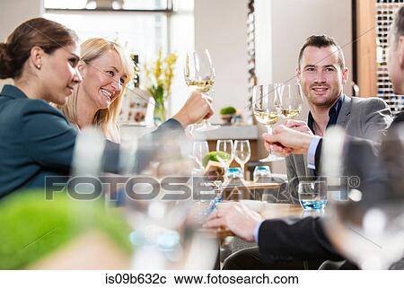 Stock Image - Businessmen and businesswomen toasting. Fotosearch