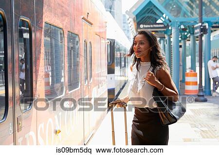 Businesswoman boarding train View Large Photo Image Stock Photography - Businesswoman boarding train. Fotosearch