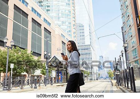 Businesswoman crossing light rail tracks View Large Photo Image Stock Image - Businesswoman crossing light rail tracks. Fotosearch