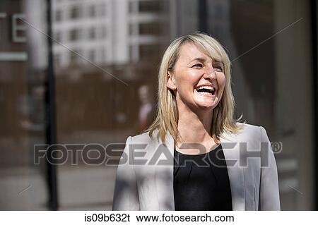 Businesswoman in front of glass building, London, UK View Large Photo Image Stock Photograph - Businesswoman in front of glass building, London, UK. Fotosearch