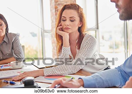 Businesswoman in meeting hand on chin looking pensive View Large Photo Image Stock Image - Businesswoman in meeting hand on chin looking pensive. Fotosearch