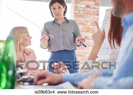 Businesswoman leading business meeting View Large Photo Image Picture - Businesswoman leading business meeting. Fotosearch