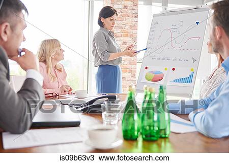 Stock Image - Businesswoman leading business meeting. Fotosearch