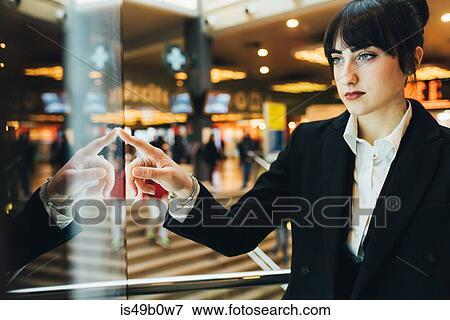 Businesswoman looking at shop window, Milan, Italy View Large Photo Image Stock Photo - Businesswoman looking at shop window, Milan, Italy. Fotosearch