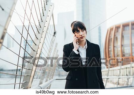 Businesswoman on pedestrian bridge, Milan, Italy View Large Photo Image Stock Image - Businesswoman on pedestrian bridge, Milan, Italy. Fotosearch