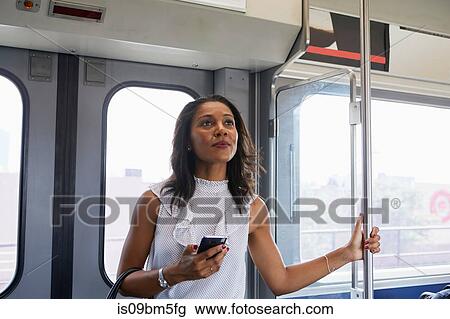Stock Image - Businesswoman on train. Fotosearch