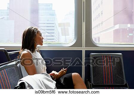 Stock Photograph - Businesswoman on train. Fotosearch