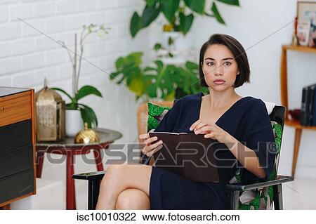 Businesswoman preparing paperwork in office View Large Photo Image Stock Image - Businesswoman preparing paperwork in office. Fotosearch