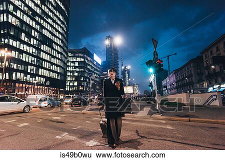 Businesswoman pulling trolley luggage, Milan, Italy View Large Photo Image Stock Photograph - Businesswoman pulling trolley luggage, Milan, Italy. Fotosearch
