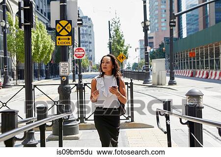 Businesswoman standing by barriers View Large Photo Image Stock Photograph - Businesswoman standing by barriers. Fotosearch