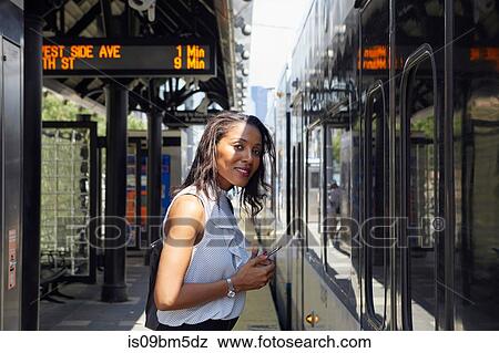 Businesswoman standing close to train View Large Photo Image Stock Photo - Businesswoman standing close to train. Fotosearch
