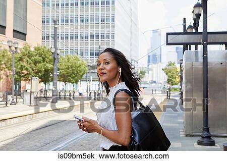 Businesswoman using cellphone in street View Large Photo Image Stock Image - Businesswoman using cellphone in street. Fotosearch