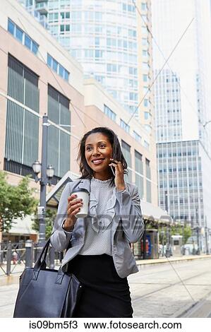 Businesswoman using cellphone in street View Large Photo Image Stock Image - Businesswoman using cellphone in street. Fotosearch