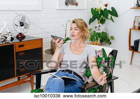 Businesswoman using cellular phone in office View Large Photo Image Stock Photo - Businesswoman using cellular phone in office. Fotosearch
