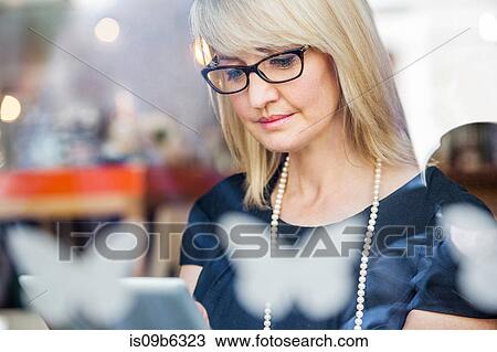 Stock Image - Businesswoman using digital tablet. Fotosearch