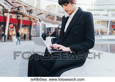 Stock Image - Businesswoman using digital tablet, Milan, Italy. Fotosearch