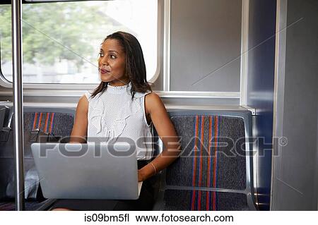 Businesswoman using laptop on train View Large Photo Image Stock Image - Businesswoman using laptop on train. Fotosearch