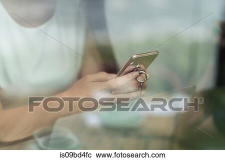 Businesswoman using smartphone and laptop, mid section, close-up View Large Photo Image Stock Image - Businesswoman using smartphone and laptop, mid section, close-up. Fotosearch