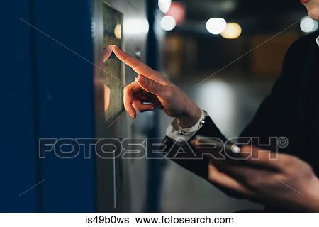 Businesswoman using ticket machine, Milan, Italy View Large Photo Image Stock Photograph - Businesswoman using ticket machine, Milan, Italy. Fotosearch
