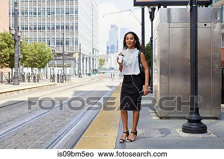 Businesswoman waiting on light rail platform View Large Photo Image Picture - Businesswoman waiting on light rail platform. Fotosearch