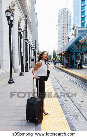 Businesswoman waiting on light rail platform View Large Photo Image Stock Image - Businesswoman waiting on light rail platform. Fotosearch