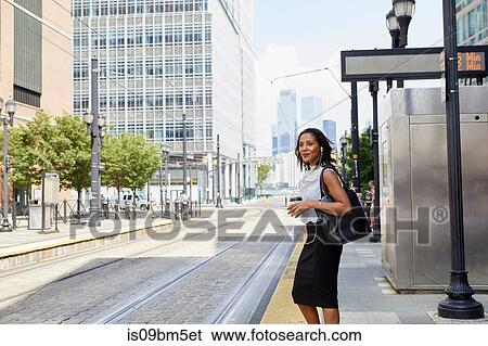 Businesswoman waiting on light rail platform View Large Photo Image Stock Photograph - Businesswoman waiting on light rail platform. Fotosearch