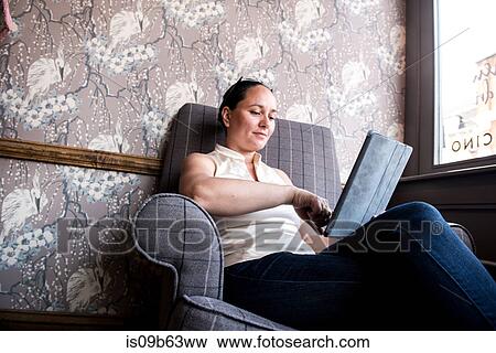 Businesswoman working on laptop in coffee bar View Large Photo Image Stock Photo - Businesswoman working on laptop in coffee bar. Fotosearch