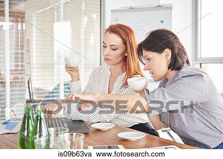 Businesswomen with coffee having discussion in meeting View Large Photo Image Stock Image - Businesswomen with coffee having discussion in meeting. Fotosearch