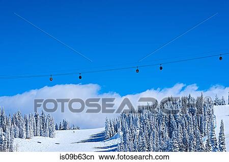 Cable car over snow covered mountains and blue sky, Aspen, Colorado, USA View Large Photo Image Picture - Cable car over snow covered mountains and blue sky, Aspen, Colorado, USA. Fotosearch