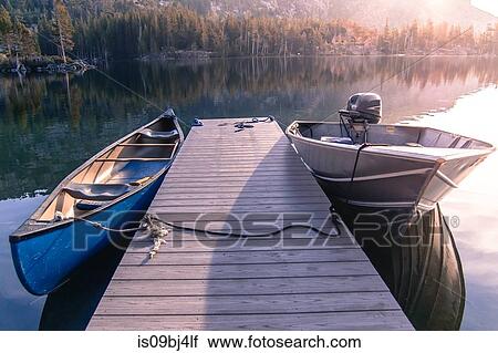 Canoe and motor boat moored at wooden pier on Echo Lake, High Sierras, California, USA View Large Photo Image Stock Image - Canoe and motor boat moored at wooden pier on Echo Lake, High Sierras, California, USA. Fotosearch