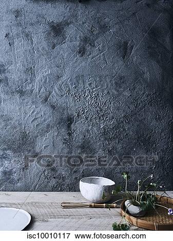 Ceramic bowls and plant against background of unfinished wall View Large Photo Image Stock Photo - Ceramic bowls and plant against background of unfinished wall. Fotosearch