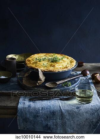 Chicken pie with glass of white wine View Large Photo Image Picture - Chicken pie with glass of white wine. Fotosearch