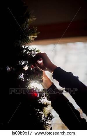 Stock Photo - Child putting up Christmas decorations. Fotosearch