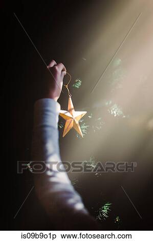 Child putting up Christmas decorations View Large Photo Image Stock Photography - Child putting up Christmas decorations. Fotosearch