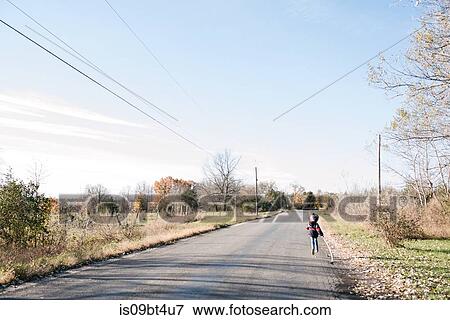 Child running on country road View Large Photo Image Stock Photo - Child running on country road. Fotosearch