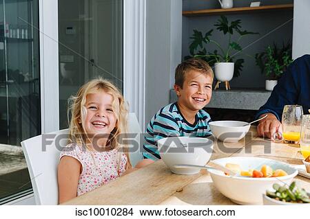 Children having lunch with father at home View Large Photo Image Picture - Children having lunch with father at home. Fotosearch